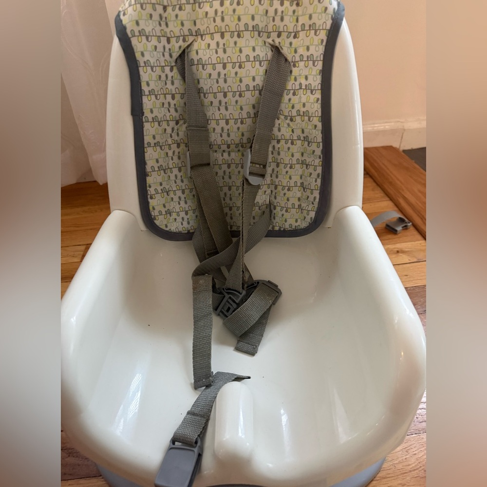 White Baby High Chair booster seat with Gray Straps and Patterned Cushion